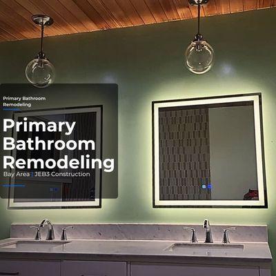 LED mirrors with green accent wall and double vanity create a clean, modern bathroom look.