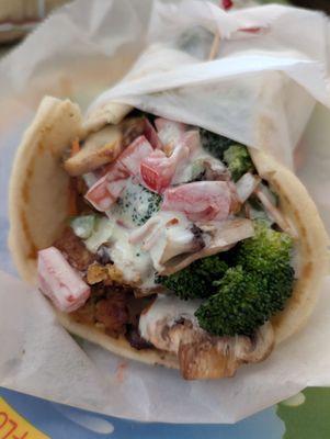 Garden Veggie Pita. Pita with garden burger strips, broccoli, mushrooms, carrots, green peppers and onions in a creamy cucumber dressing.