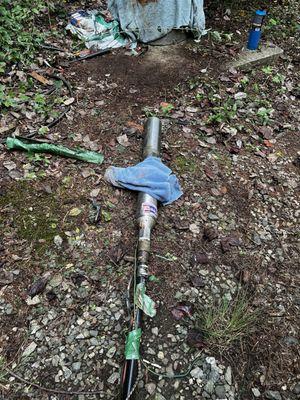 Zoom in and you can see the rope was never attached to the hook on the well its 6-8 inches away from it