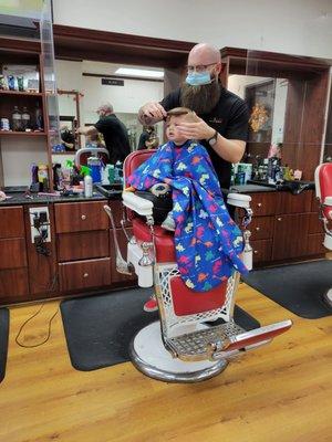 Blake cutting grandson's hair
