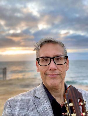 Ceremony guitarist, Alex Guillen getting ready at Sunset Cliffs to perform at an elopement.