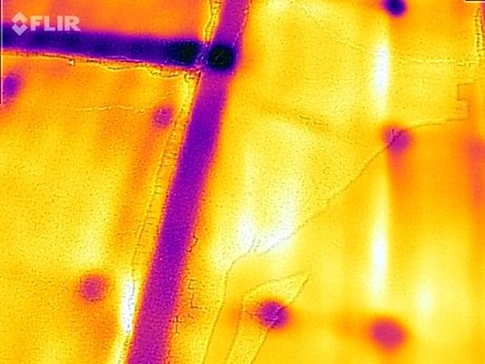 Infrared Photo of a roof with failing seams. The dark spots represent water trapped under the roof.