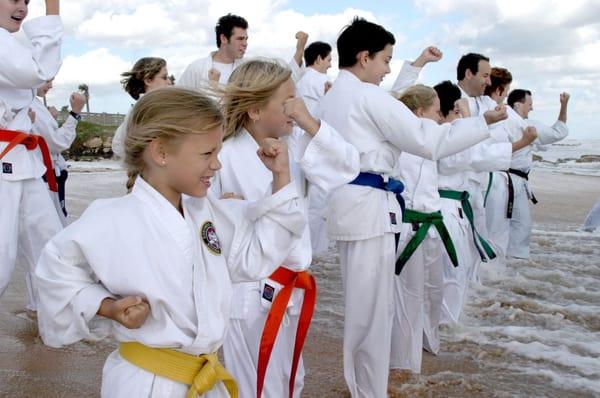 Palm Coast children and adults working together on their martial arts skills.
