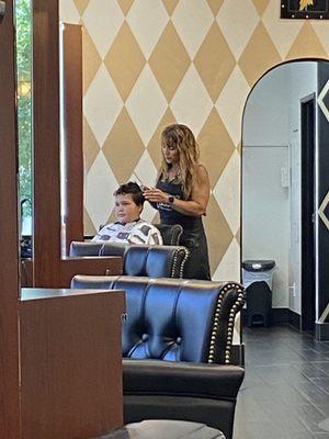 Courtney cutting Ethan's hair.