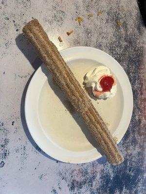 Churro with whipped cream and a cherry . Our awesome server divided in half for us.
