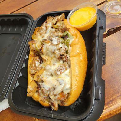 Lamb Philly sandwich with provolone cheese, side of cheese whiz