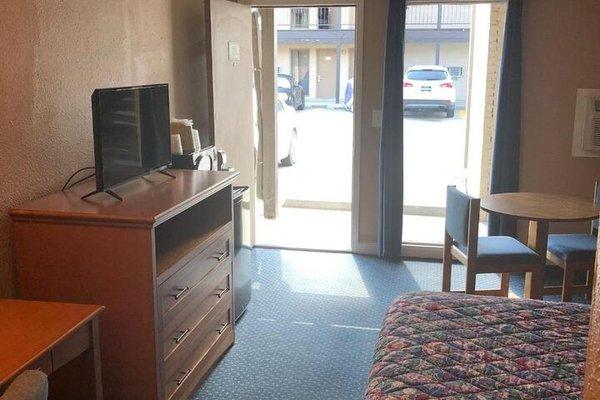 Open air motel with table chairs and tv
