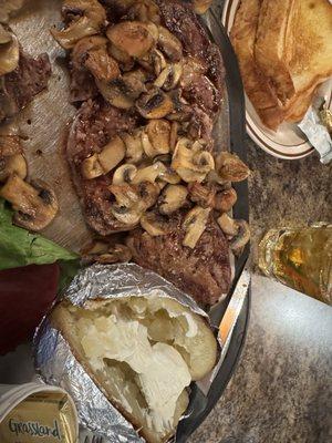 Rib Eye steak, sautéed mushrooms and baked potato