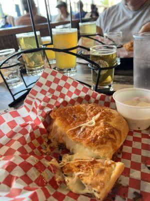 Half of a Buffalo Chicken calzone and a beer flight.