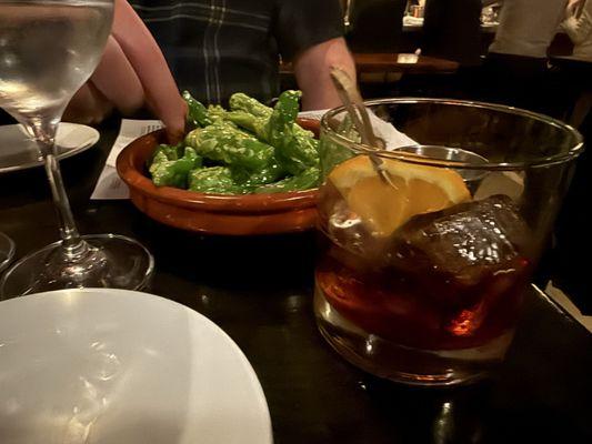 Vermut and shishito peppers.