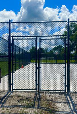 Double drive gate for a 10 ft. Black vinyl fence for a community center basketball court.
