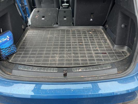 Cargo area before. Pink paint spill on the folded down seat on the left.