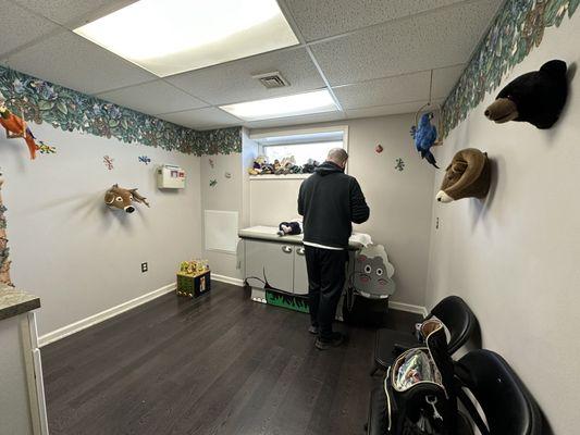 The exam room- My husband with my twins on the table.