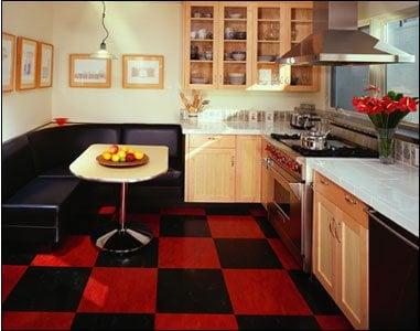 A whimsical but elegant kitchen with tile countertops, custom hood, and bamboo cabinets