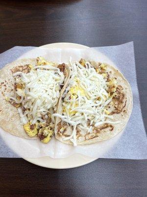 Two egg and bacon breakfast tacos and I added cheese!