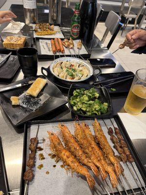 Shrimp skewers, lamb skewers, smashed cucumbers, clams
