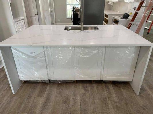 Calacatta Gold Quartz Island with Waterfalls and White Shaker Cabinets