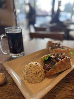 Grilled chicken sandwich on French roll with potato salad with coffee