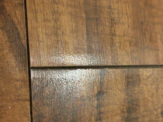 warped laminate flooring becaue they did not protect the floor and brought water into the room