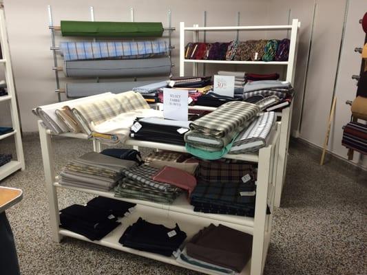 Down in a corner of the bargain basement, there are bolts of plaid cloth for those handy with a needle.