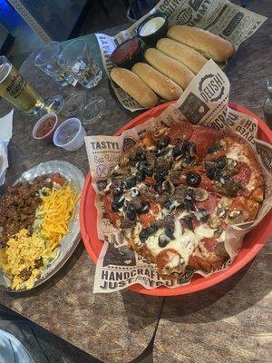 Individual Combination Pizza, Nacho Salad, garlic bread sticks.