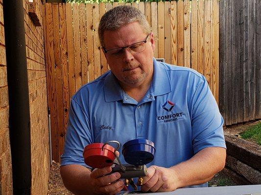 Me adjusting a refrigerant charge on an install