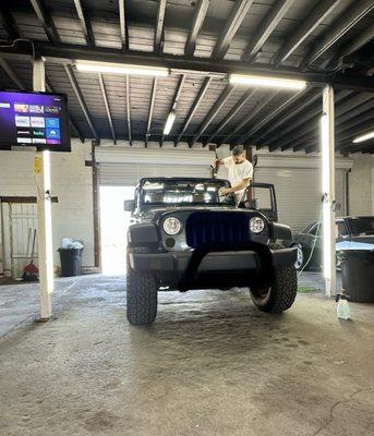 Nice, well-lit installation area with TV for customers