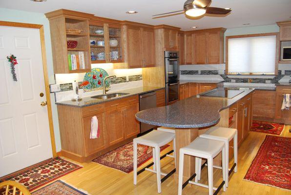 After: The client wanted a fish mural backsplash. We worked together to come up with the design. The island is a guitar shape with seating.