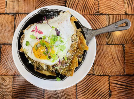 Pork Verde Chilaquiles (Pulled Pork, Salsa Verde, Tortilla Chips, Fried Egg, Cotija Cheese, Cilantro).