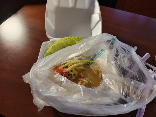 Thai papaya salad placed in a plastic bag - order Mild as medium Spicy is HOT!!!