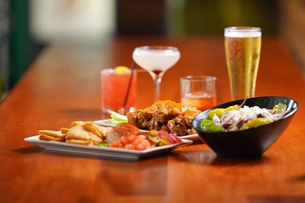 Featured cocktails, brews, fish dip, wings & salad.