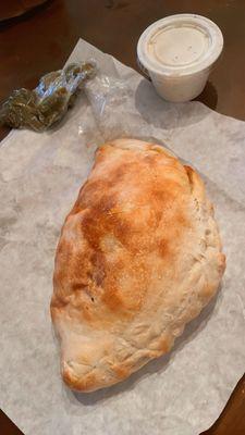 Half of a regular pizza pocket with ranch and jalapeños (we ordered a full one, but the half slice is for the picture)