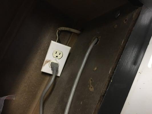 How the microwave is plugged in, the cupboard above it.