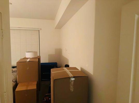 Neatly stacked moving boxes of various sizes ready for relocation.