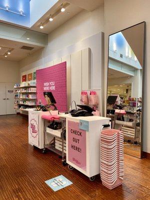 Register area underneath the escalator to check out