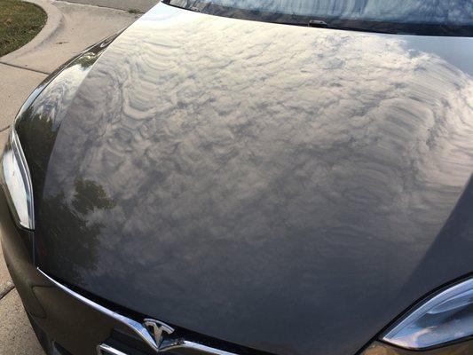 My Tesla hood, previously covered in scratches from a tree flying off a landscape truck on the highway- Steve made her beautiful again!
