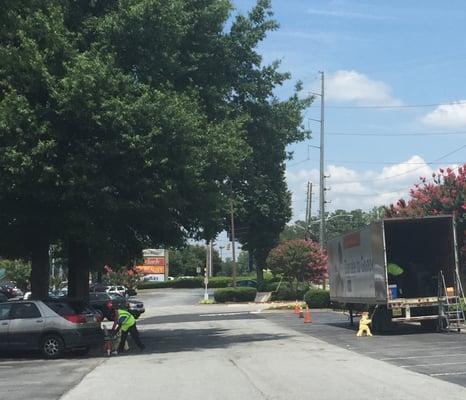 Sitting in front of the car he just put donated items into