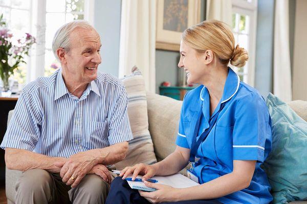 Senior sitting with caregiver | Legacy Ridge at Peachtree
