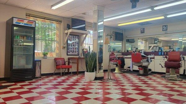Interior. Five chairs and a mother-son barbers duo.