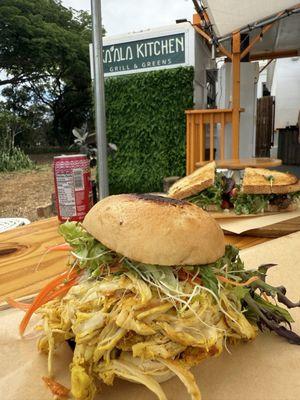 Chicken sandwich on GF roll. Steak sandwich on sourdough in the background.