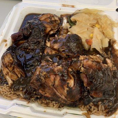Spicy Jerk chicken with rice and beans + cabbage.
