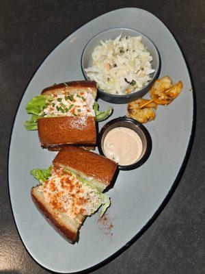 The Trio of Seafood : Lobster and crab roll with sauce, and a skewer of shrimp. Plus cold slaw.