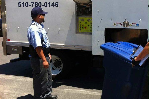 A Bay Area Shredding employee monitoring the document shredding process for an on-site shredding customer.