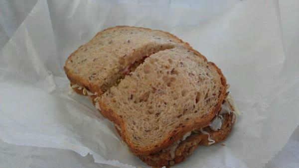 Turkey, brie, tomato, lettuce, and mayo on multigrain bread.