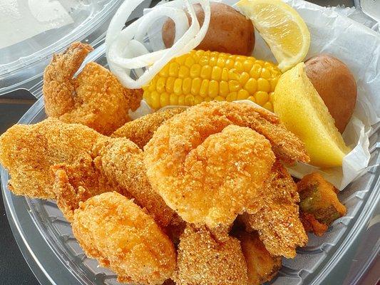 Fried fish and shrimp combo with corn potatoes and fried okra