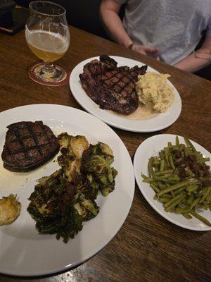 24 oz. boneless ribeye with mashed potatoes, 8 oz. filet with brussels sprouts, and green beans.