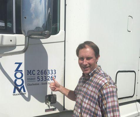 Satisfied customer gives a thumbs up after receiving a truck load of auto parts to keep his plant up and running.