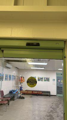 Look up. The black box above is the "eye" to open the automatic doors.