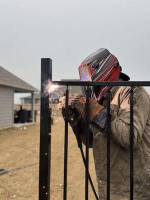 Welding wrought iron panel to 2" post no brackets