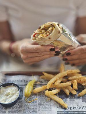 Juicy chicken shawarma wrap with crispy seasoned fries and garlic sauce. Perfect combo